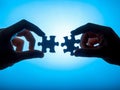 Hands Connecting Puzzle Pieces Against Blue Background Royalty Free Stock Photo