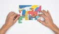 Hands Connecting Puzzle Pieces for a Solution Royalty Free Stock Photo
