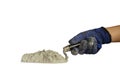 The hands of the construction worker holding a trowel, including cement or cement powder, isolated on a white background. Royalty Free Stock Photo