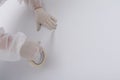 Hands of a construction worker in protective clothing, pasting paint tape to create a multi-colored interior, on a white wall Royalty Free Stock Photo