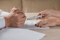 Hands of contractual parties, a woman and a man, signing a contract Royalty Free Stock Photo