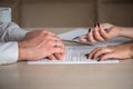 Hands of contractual parties, a woman and a man, signing a contract Royalty Free Stock Photo