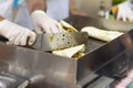 Hands of cook close-up. Process of preparing a quesadilla, burrito, fajitas. Outdoor outside setting, authentic street