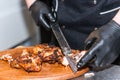 Hands cook cut fried meat