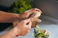hands of cook cut peel of raw potatoes , put food waste in separate container for further processing. Zero waste, using Royalty Free Stock Photo