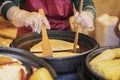 Hands of cook in gloves and apron close-up. Process of preparing quesadilla, burrito, fajitas. Authentic street food