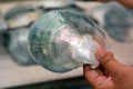 Hands of a Cook Islander man polishing Tahitian Black Pearl she