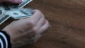 Female hands count dollar bills and inspecting to found unfit banknotes