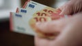 Hands counting small savings indoors closeup. Unknown man calculating euro bills Royalty Free Stock Photo