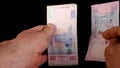 Hands counting stack cash two hundred Ukrainian hryvnia bills, recalculation banknotes.