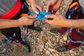 Hands of a couple of climbers making the eight knot in her harness to start climbing. Working as a team and in love