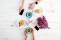 Hands of couple drinking coffee with croissants on wooden table Royalty Free Stock Photo