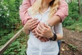 Hands of a couple in love. Man and woman are standing embracing.