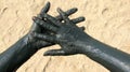 Hands covered with therapeutic mud