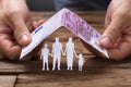 Hands Covering Family Under House Roof Made From Euro Note Royalty Free Stock Photo