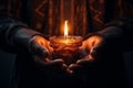 Hands cradling a candle, with its soft, warm glow as the sole source of light, symbolizing the power of a single flame to dispel