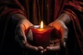 Hands cradling a candle, with its soft, warm glow as the sole source of light, symbolizing the power of a single flame to dispel