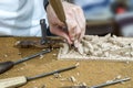 Hands of the craftsman carve a bas-relief Royalty Free Stock Photo