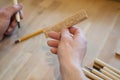 Hands of the craftsman carve with a gouge. Wood carving. Wood carving set on a wooden table. Royalty Free Stock Photo