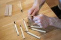 Hands of the craftsman carve with a gouge. Wood carving. Wood carving set on a wooden table.