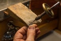 Hands of a craftsman jeweler working on jewelry. Goldsmith. Jewelry and valuables workshop. Goldsmith Hand Drill.