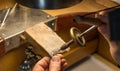 Hands of a craftsman jeweler working on jewelry. Goldsmith. Jewelry and valuables workshop. Goldsmith Hand Drill.