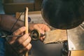 Hands of a craftsman jeweler working on jewelry. Goldsmith. Jewelry and valuables workshop. Goldsmith Hand Drill.