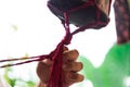 Hands of a craftsman knitting handmade macrame.