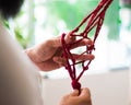 Hands of a craftsman knitting handmade macrame. Royalty Free Stock Photo