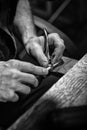 Hands of an craftsman working with the metal tongs Royalty Free Stock Photo