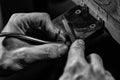 Hands of an craftsman working with the metal tongs Royalty Free Stock Photo