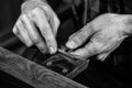 Hands of an craftsman working with the metal tongs Royalty Free Stock Photo