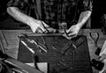 Hands of an craftsman working with the metal tongs Royalty Free Stock Photo