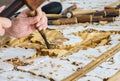 Hands of the Craftsman Working on Wooden Carving in Vintage Floral Pattern