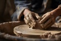 Hands create a pottery bowl on a wheel in a workshop surrounded by tools and clay Royalty Free Stock Photo