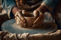 Hands create a pottery bowl on a wheel in a workshop surrounded by tools and clay Royalty Free Stock Photo
