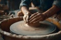 Hands create a pottery bowl on a wheel in a workshop surrounded by tools and clay Royalty Free Stock Photo