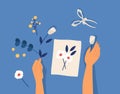 Hands creating decorative craftwork or handiwork - flower applique, herbarium, scarpbooking. Creative workshop lesson or Royalty Free Stock Photo