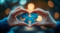 Hands creating heart shape around puzzle piece, symbolizing care and unity for autism awareness Royalty Free Stock Photo