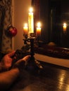 Hands with crucifix and candles in the dark Royalty Free Stock Photo