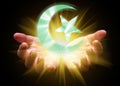 Hands cupped and holding or showing the Islamic Crescent Moon and Star Royalty Free Stock Photo