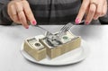 Hands Cut money on plate, reduce funds concept Royalty Free Stock Photo