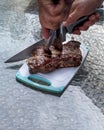 Hands cut stake with knife and fork. Delicious grilled fresh meat on barbecue grill. Grilling stake outside.