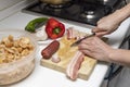 Hands cutting bacon. Extremadura crumbs, traditional home cooking with bacon, chorizo, garlic, breadcrumbs, red and green peppers