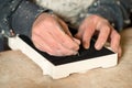 Hands Cutting Black Felt Paper on a Plaster Model Royalty Free Stock Photo
