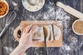 Hands cutting dough. Preparation recipe bread, pizza or pie making ingridients, food flat lay on kitchen table background Royalty Free Stock Photo