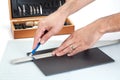 Hands cutting a foam board with sharp knife Royalty Free Stock Photo