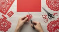 Hands Cutting Red Paper with Scissors Royalty Free Stock Photo