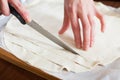 Hands cutting store-bought dough