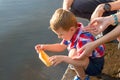 Hands of a Dad and Mom, who helps the little boy to lower the pa Royalty Free Stock Photo